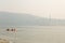 VANCOUVER, BC, CANADA - AUG 20, 2018: Children play in the ocean near a North Vancouver beach with the haze from forest