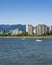 VANCOUVER, CANADA - MAY 08, 2020: sailboat and yacht in Burrard Inlet tall buildings with clear blue sky