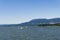 VANCOUVER, CANADA - MAY 08, 2020: sailboat and yacht in Burrard Inlet tall buildings with clear blue sky