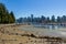The Vancouver Skyline and Stanley Park sea wall at low tide in summer