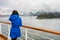 Vancouver tourist girl in blue raincoat leaving city on Alaska cruise. Voyage to the Arctic. Woman lifestyle in Autumn