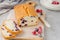 Vanilla cake or sponge cake with blueberries on a board on a gray concrete background.