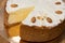 Vanilla cheesecake on the plate. Sweet creamy cake with almond nut. Yogurt dessert. Cheesecake in cafe showcase.