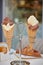 Vanilla and chocolate mixed Ice cream waffle sugar cones in metal holder on the table croissant sugar holder and sugar