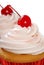 Vanilla cupcake with maraschino cherry