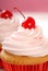 Vanilla cupcake with maraschino cherry