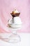 Vanilla cupcake with whipper cream on pink background