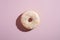 Vanilla donut with sprinkles, sweet glazed dessert food on pink minimal background