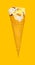 vanilla flaovr ice cream cone with some bites on a yellow background