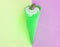 Vanilla green ice cream cone with chocolate on a background of pastel shades of green and lilac, tinted shot