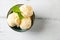 Vanilla ice cream balls with mint in a turquoise bowl