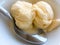 Vanilla ice cream in bowl with spoon