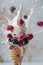 Vanilla ice cream cone with assorted berries, blackberries, blueberries, and raspberries, and dynamic milk splash on a