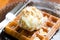 Vanilla ice cream scoop on waffle