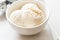 Vanilla ice cream scoops in white bowl