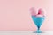 Vanilla pink strawberry ice cream scoops in elegant plastic blue bowl in modern stylish pastel pink interior.