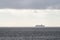Vanishing cruise ship in haze of blue water