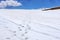 Vanishing human footprints on the snow in the winter Caucasus mountains. SCenic landscape