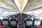 Vanishing row of black and red seats in airplane.