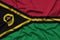 Vanuatu flag is depicted on a sports cloth fabric with many folds. Sport team banner