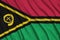 Vanuatu flag is depicted on a sports cloth fabric with many folds. Sport team banner