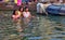 Varanasi, India: A happy family of Father and daughters performing prayer and hindu ritual in holy Ganges