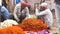 VARANASI, INDIA - MAR 10, 2019: Unidentified people sell flowers for the religious purposes at flower market in Varanasi