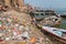 VARANASI, INDIA - OCTOBER 25, 2016: Pile of trash at a Ghat riverfront steps of sacred river Ganges in Varanasi, Ind