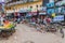 VARANASI, INDIA - OCTOBER 25, 2016: Street fruit stalls and cyclo rickshaws in Varanasi, Ind