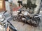 Varanasi, India: An old rusty damaged and flat tired Indian motor bike parked in a grungy corner of an alley