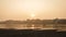 Varanasi, Uttar Pradesh, India - Landscape of Ganges River, or Ganga with boats in yellow sunset sky.