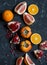 Variation of fresh fruit - grapefruit, persimmon, pomegranate, orange. On the dark background