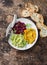 Variations of hummus. Pumpkin, turmeric, avocado, beetroot hummus with olive oil, sesame seeds and micro greens on a wooden backgr