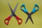 Variations of layouts of stationery items, scissors on a colored background