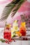 Variations of lemonades with different fruits and syrups on wooden table under morning sun