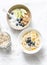 Varied breakfast - yogurt with granola and fruit, vegetarian oatmeal with fruit and berries on a light background