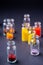 Varied colors beads in transparent bottles dark background