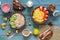 Varied healthy breakfast on a blue rustic background. Corn flakes, strawberries, muesli, kiwi, almonds, milk, berry mousse, baked