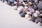 Varied pebbles on white background angle view