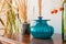 Varied vases with dry plants on an old antique vintage mahogany chest of drawers