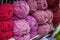 Variegated pile of knitting yarn for knitting in shades of purple, pink, violet. Store of goods for creativity and