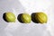 Variegated pink lemons or pink-fleshed Eureka lemons on gray concrete table, top view. Whole citrus fruits with striped rind