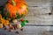 Variegated pumpkin and nuts on an old board, with space for text