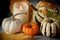 Variegated red, white mini pumpkins, different varieties and types, and yellow leaves.  Autumn still life.