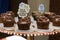 Varieties of cupcake with decorative plate with the phrase `Carrot cake with brigadier`.and `Chocolate Chip Chocolate Cake`