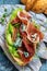 Variety of aperitifs Croissant sandwiches with jamon ham serrano paleta iberica, blue cheese, avocado, microgin on blue background