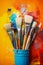 A variety of artist paint brushes laid out on a vibrant background, in art class extracurricular hobby at school or