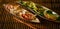 Variety Asian dumplings Gyozas with meat and vegetables potstickers fried on ceramic plate, served with chopsticks over wooden