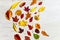 Variety of autumn leaves on white wooden background with space to insert your text. Autumn background concept