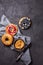 Variety of bagels with different toppings and natural paleo nut peanut cashew creamy butter on dark gray background